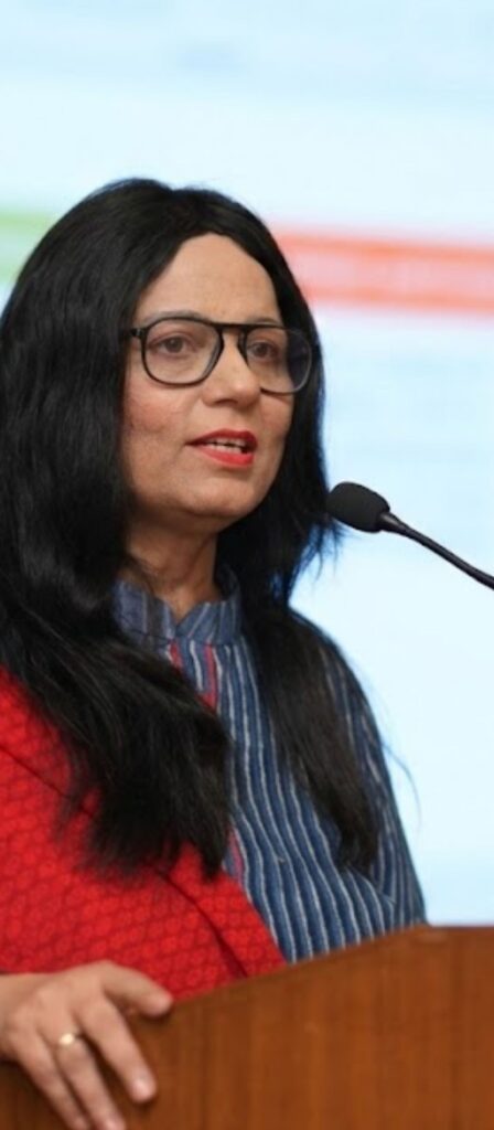 Sarita Chugh coach speaking at podium with mic