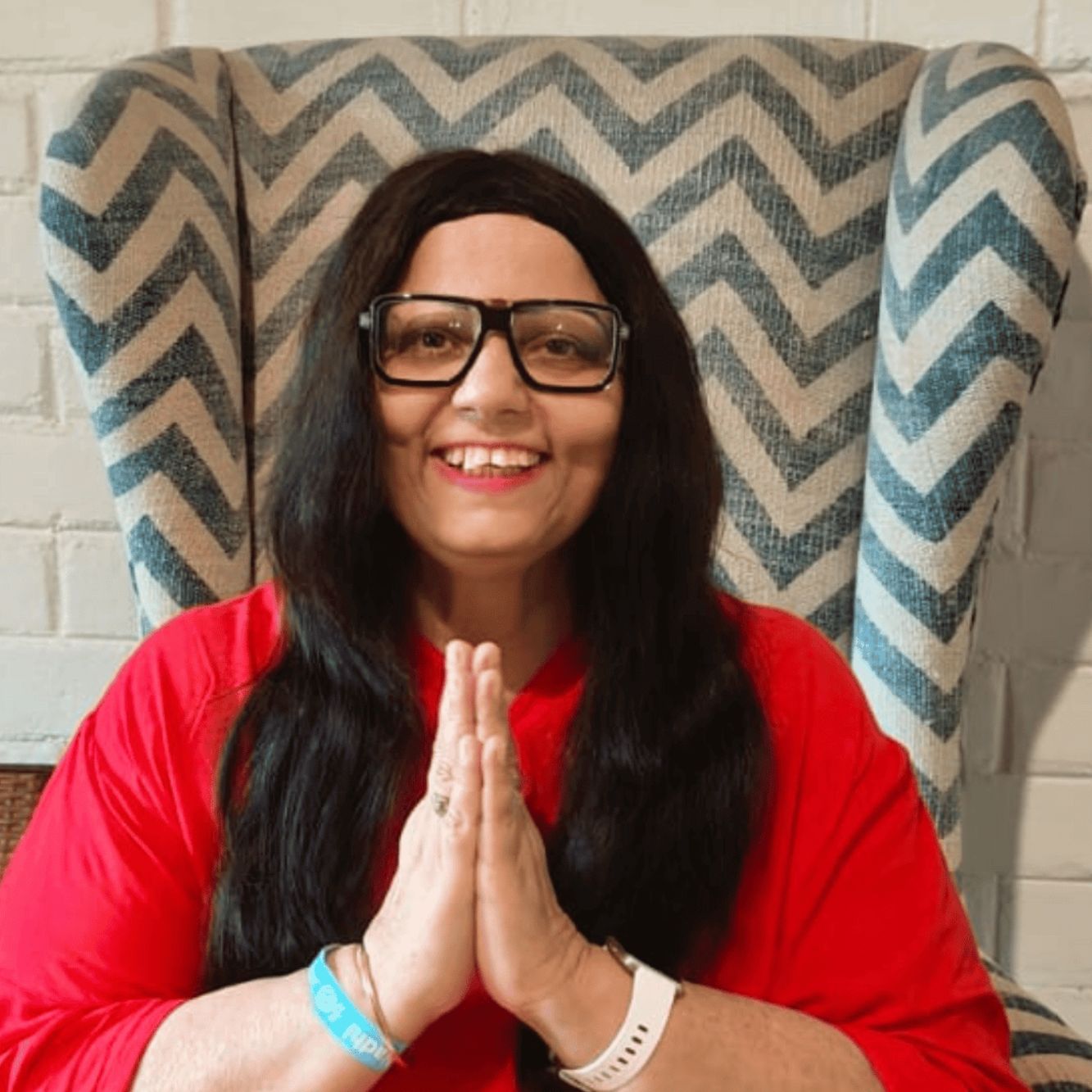 Sarita Chugh coach smiling with hands together